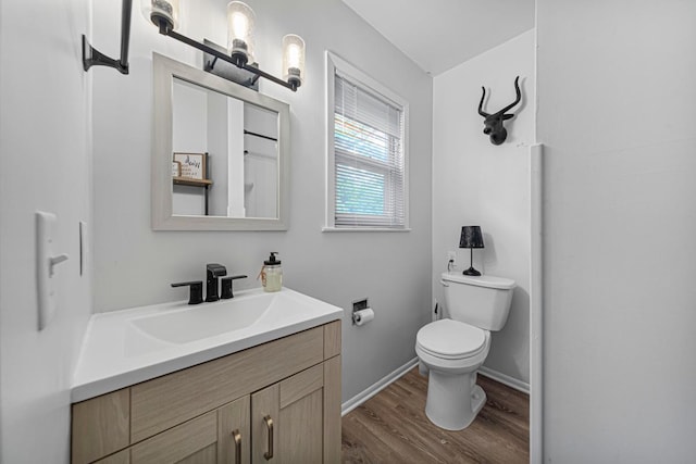 1819 4th Ave, Mankato, MN 56001 - full bath featuring vanity, wood finished floors, toilet, and baseboards