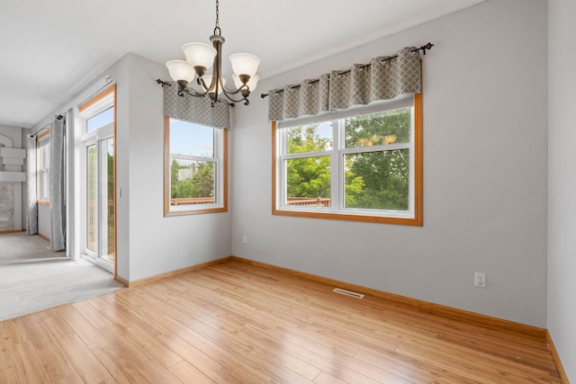6701 Urbandale Ln N, Maple Grove, MN 55311 - empty room featuring a chandelier and wood finished floors