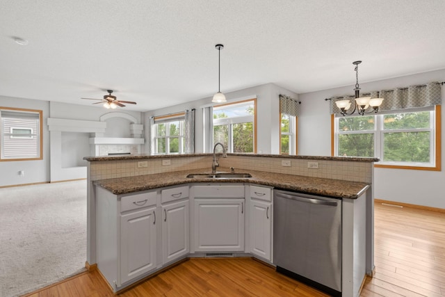 6701 Urbandale Ln N, Maple Grove, MN 55311 - kitchen with dishwasher, backsplash, ceiling fan, a chandelier, and hanging light fixtures