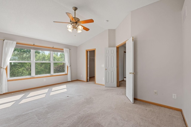 6701 Urbandale Ln N, Maple Grove, MN 55311 - unfurnished bedroom with light carpet, a walk in closet, a ceiling fan, and high vaulted ceiling