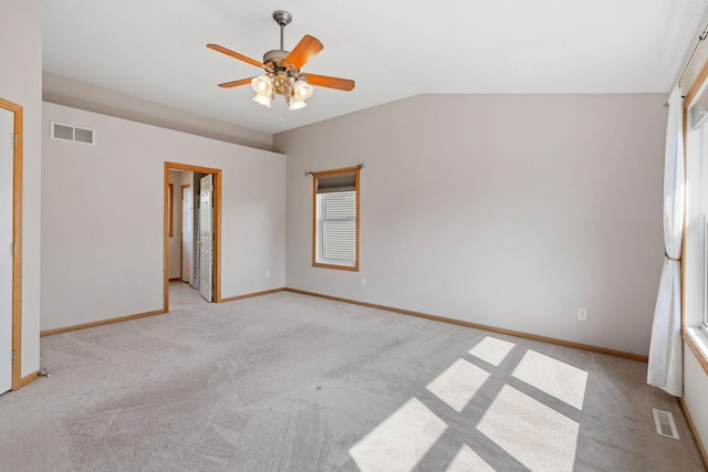 6701 Urbandale Ln N, Maple Grove, MN 55311 - empty room with a ceiling fan, light colored carpet, vaulted ceiling, and plenty of natural light