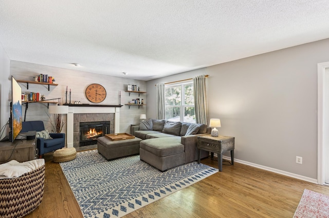 2740 Simons Dr, Chaska, MN 55318 - living room featuring a textured ceiling, wood finished floors, and a fireplace