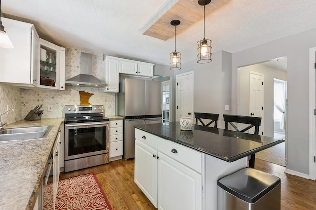 2740 Simons Dr, Chaska, MN 55318 - kitchen featuring appliances with stainless steel finishes, wall chimney exhaust hood, dark wood-style floors, backsplash, and a textured ceiling
