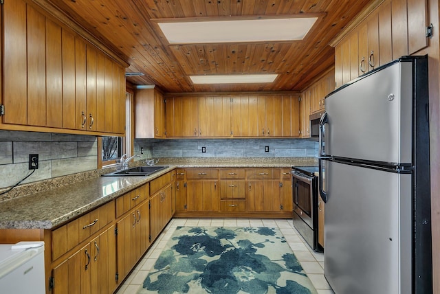 21014 Elmway Rd, Richmond, MN 56368 - kitchen featuring stainless steel appliances, light tile patterned floors, decorative backsplash, a skylight, and wood ceiling