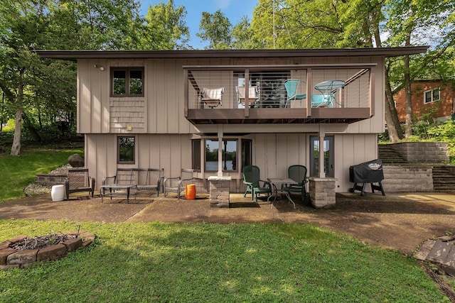 21014 Elmway Rd, Richmond, MN 56368 - back of house with an outdoor fire pit, a yard, a patio area, and a balcony