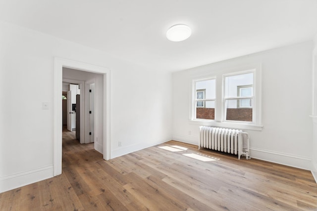 987 Dayton Ave, Saint Paul, MN 55104 - unfurnished room with radiator, wood finished floors, and baseboards