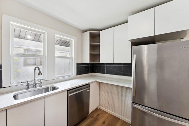 987 Dayton Ave, Saint Paul, MN 55104 - kitchen featuring appliances with stainless steel finishes, a sink, open shelves, white cabinets, and wood finished floors