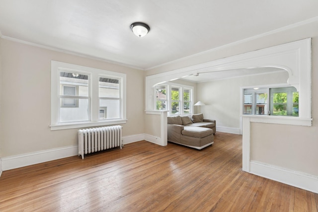 987 Dayton Ave, Saint Paul, MN 55104 - living area featuring radiator heating unit, wood finished floors, ornamental molding, and baseboards