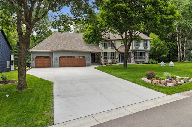 1561 Creek Run Trl, Chanhassen, MN 55331 - view of front of property with an attached garage, a front lawn, stone siding, and concrete driveway