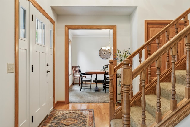 1561 Creek Run Trl, Chanhassen, MN 55331 - foyer entrance with a chandelier, stairway, ornamental molding, and wood finished floors