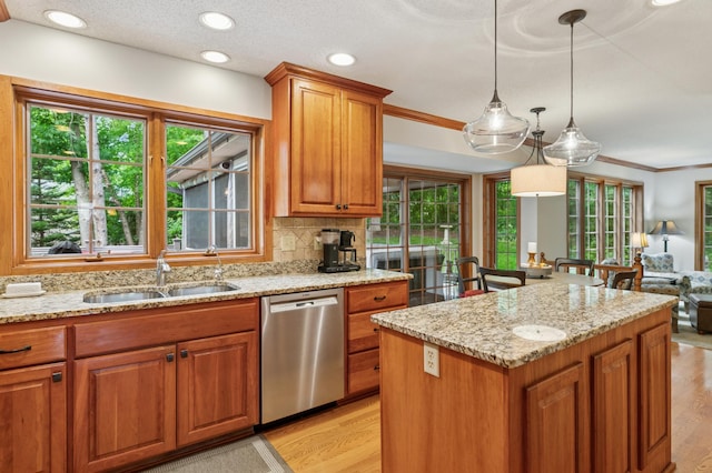 1561 Creek Run Trl, Chanhassen, MN 55331 - kitchen featuring stainless steel dishwasher, light wood-style flooring, light stone counters, healthy amount of natural light, and ornamental molding