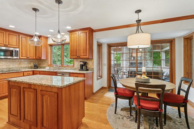 1561 Creek Run Trl, Chanhassen, MN 55331 - kitchen with stainless steel appliances, backsplash, brown cabinets, light wood finished floors, and light stone countertops
