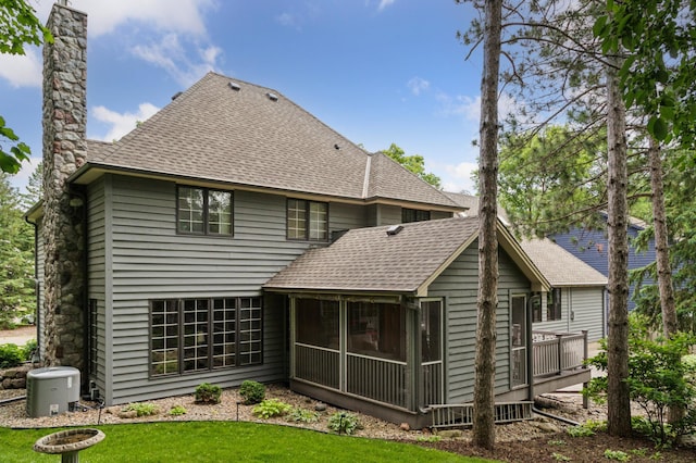 1561 Creek Run Trl, Chanhassen, MN 55331 - rear view of property with roof with shingles, a sunroom, a chimney, and a yard