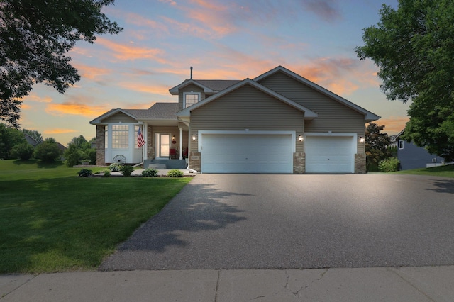 13589 Birch Rd, Rogers, MN 55374 - traditional-style home featuring asphalt driveway, an attached garage, a lawn, and stone siding