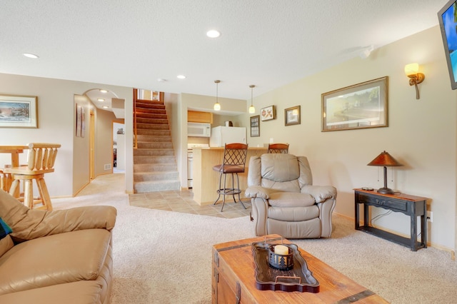13589 Birch Rd, Rogers, MN 55374 - living area featuring light colored carpet, stairway, recessed lighting, arched walkways, and a textured ceiling