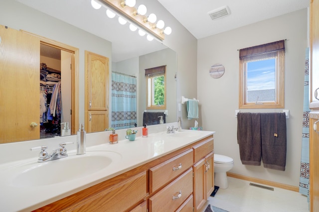 13589 Birch Rd, Rogers, MN 55374 - full bathroom featuring double vanity and toilet