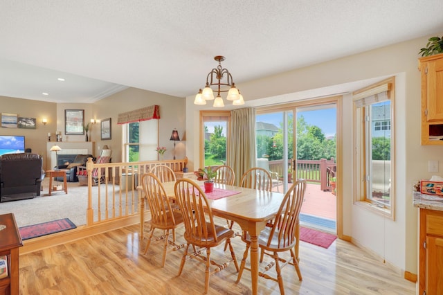 13589 Birch Rd, Rogers, MN 55374 - dining area with light wood finished floors, recessed lighting, a chandelier, and a fireplace