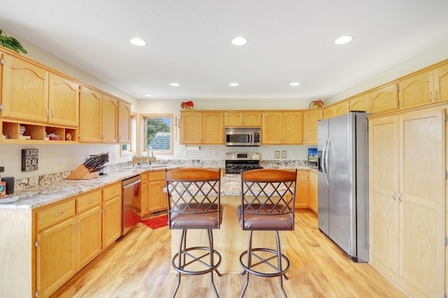 13589 Birch Rd, Rogers, MN 55374 - kitchen with appliances with stainless steel finishes, a kitchen island, light brown cabinets, a breakfast bar, and recessed lighting
