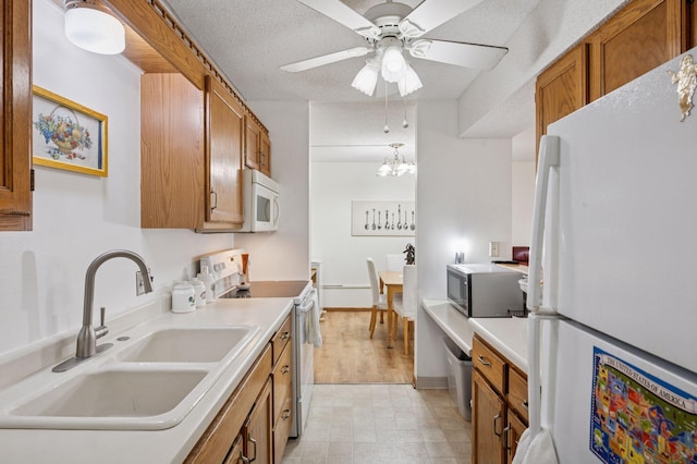 2601 Kenzie Ter Unit 402, Saint Anthony, MN 55418 - kitchen with white appliances, brown cabinets, light flooring, and ceiling fan