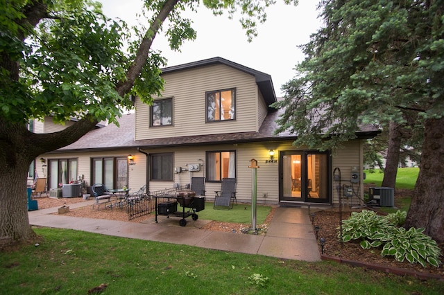 544 Auburn Pl NW Unit H, Elk River, MN 55330 - rear view of house with a patio area, a yard, and roof with shingles