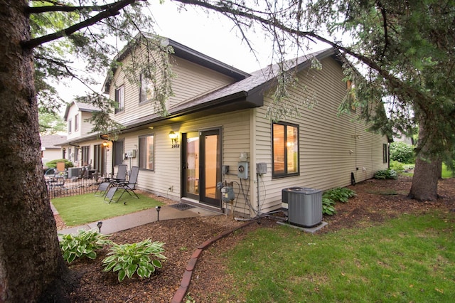 544 Auburn Pl NW Unit H, Elk River, MN 55330 - rear view of house with a patio and a lawn