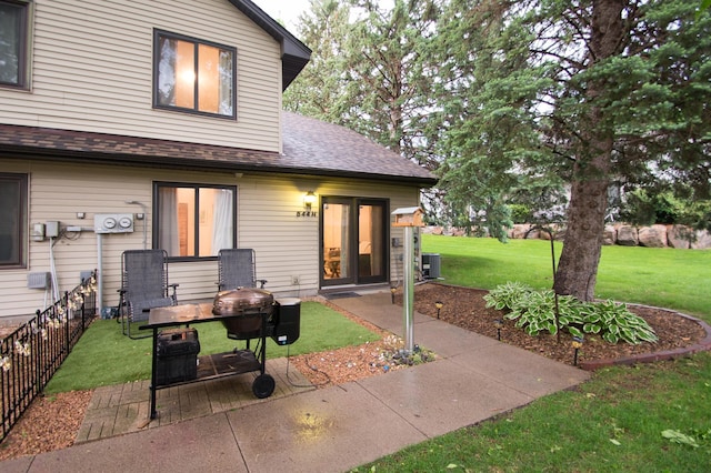 544 Auburn Pl NW Unit H, Elk River, MN 55330 - rear view of property featuring a yard, a patio area, and a shingled roof