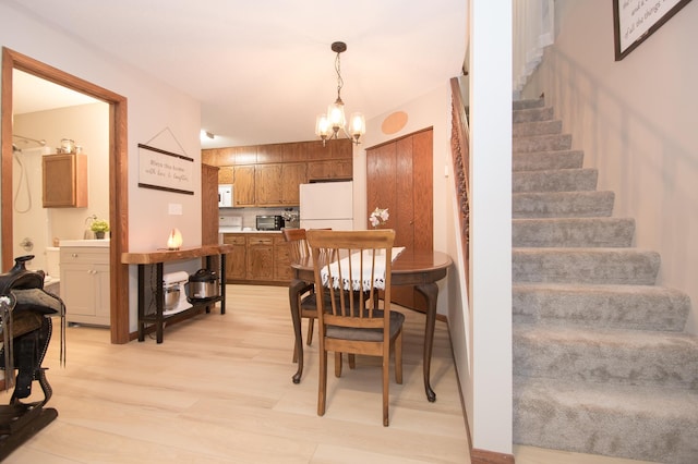 544 Auburn Pl NW Unit H, Elk River, MN 55330 - dining room featuring a chandelier, stairway, and light wood finished floors