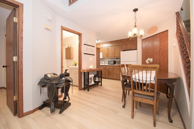 544 Auburn Pl NW Unit H, Elk River, MN 55330 - dining area with light wood-style floors and a chandelier