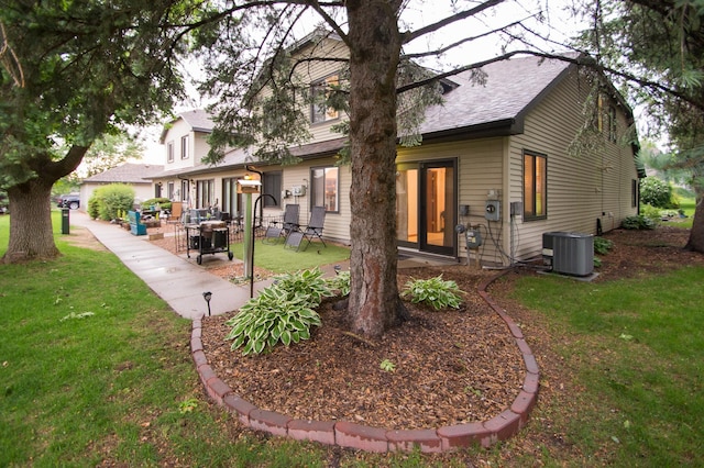 544 Auburn Pl NW Unit H, Elk River, MN 55330 - back of house featuring a lawn, a patio area, and roof with shingles