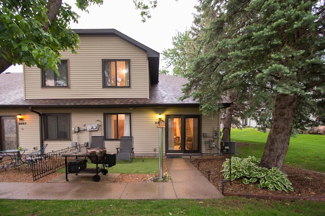 544 Auburn Pl NW Unit H, Elk River, MN 55330 - view of front of house featuring a patio area, a front lawn, and roof with shingles