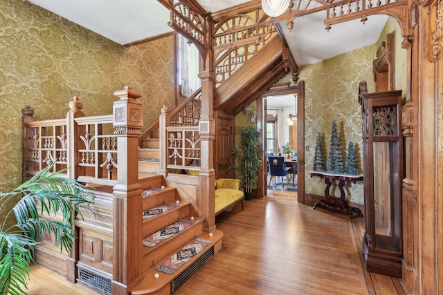 1601 Park Ave, Minneapolis, MN 55404 - staircase featuring wallpapered walls and hardwood / wood-style flooring