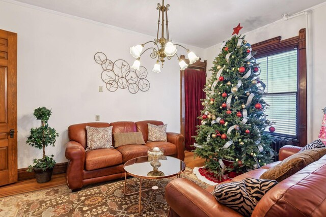 1601 Park Ave, Minneapolis, MN 55404 - living area featuring wood finished floors, a chandelier, and ornamental molding