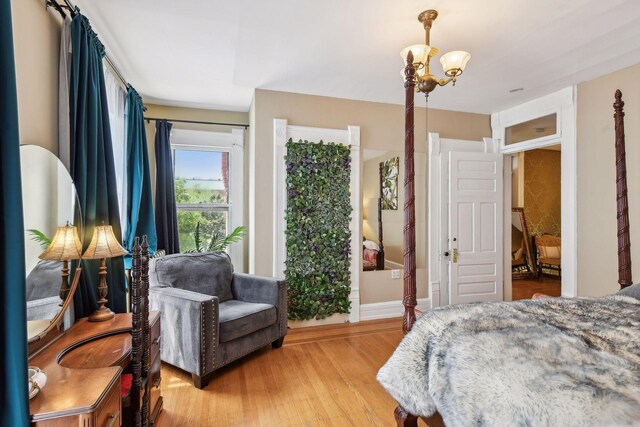 1601 Park Ave, Minneapolis, MN 55404 - bedroom with light wood-type flooring and a chandelier