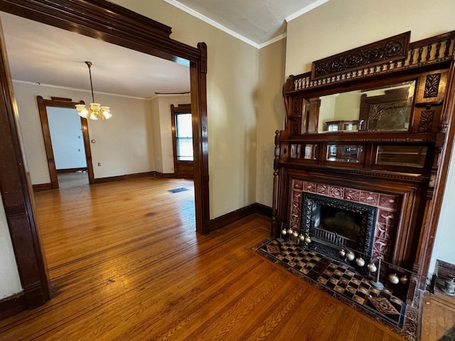 1601 Park Ave, Minneapolis, MN 55404 - living area featuring crown molding, a chandelier, wood finished floors, and a tile fireplace