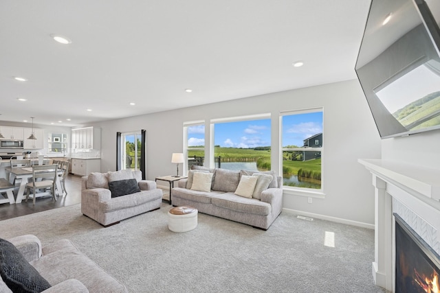 11604 Brayburn Trl, Dayton, MN 55369 - living room featuring a warm lit fireplace and recessed lighting