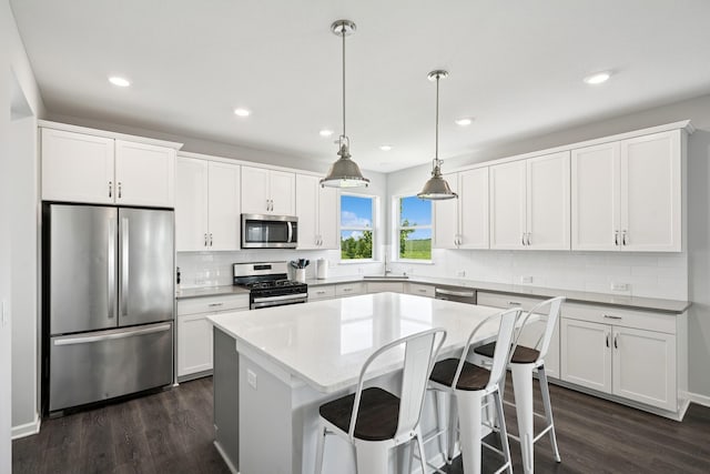 11604 Brayburn Trl, Dayton, MN 55369 - kitchen with stainless steel appliances, dark wood-type flooring, a center island, backsplash, and recessed lighting
