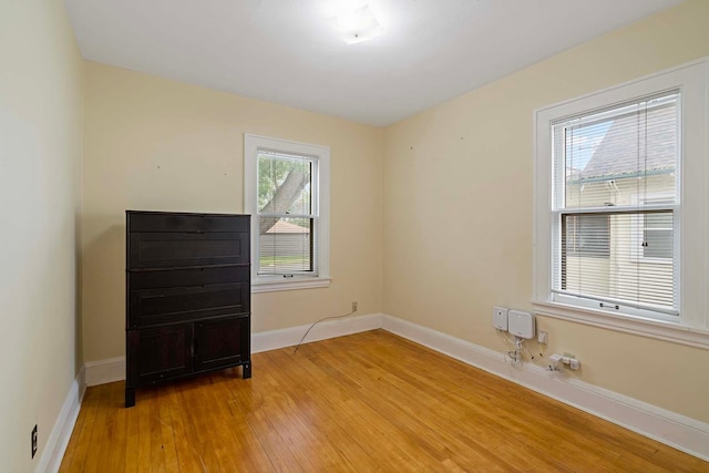 67 Lowry Ave NE, Minneapolis, MN 55418 - spare room with light wood-style floors and baseboards