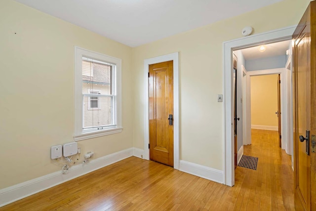 67 Lowry Ave NE, Minneapolis, MN 55418 - unfurnished bedroom featuring light wood-style floors and baseboards