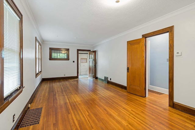 67 Lowry Ave NE, Minneapolis, MN 55418 - unfurnished room with wood finished floors and ornamental molding