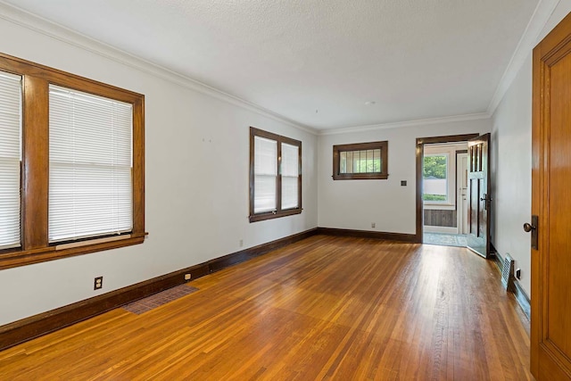 67 Lowry Ave NE, Minneapolis, MN 55418 - spare room featuring wood finished floors and crown molding
