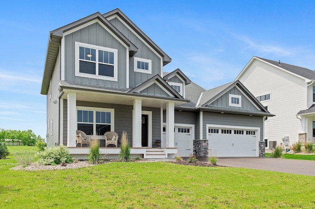 17660 Jett Cir, Prior Lake, MN 55372 - craftsman-style house featuring board and batten siding, covered porch, driveway, a front lawn, and a garage