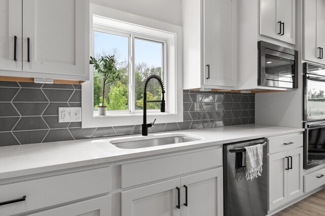 17660 Jett Cir, Prior Lake, MN 55372 - kitchen with stainless steel appliances, decorative backsplash, white cabinetry, and light stone countertops