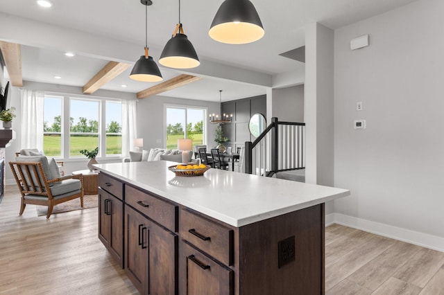 17660 Jett Cir, Prior Lake, MN 55372 - kitchen featuring beam ceiling, a chandelier, light wood-type flooring, open floor plan, and dark brown cabinetry
