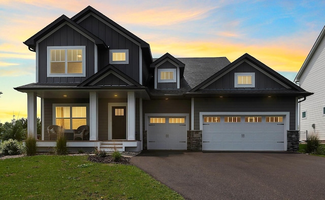 17660 Jett Cir, Prior Lake, MN 55372 - craftsman inspired home featuring asphalt driveway, board and batten siding, a porch, and a yard
