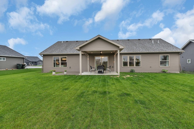 83 Meadow Ln, Cold Spring, MN 56320 - rear view of property featuring a patio area, a shingled roof, and a lawn