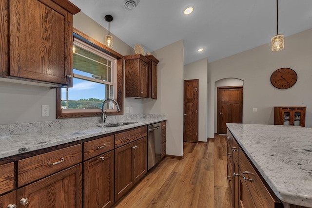 83 Meadow Ln, Cold Spring, MN 56320 - kitchen with stainless steel dishwasher, a sink, arched walkways, light wood-style floors, and pendant lighting