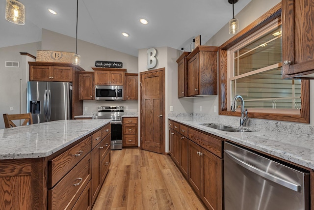 83 Meadow Ln, Cold Spring, MN 56320 - kitchen featuring appliances with stainless steel finishes, a sink, light wood-style floors, lofted ceiling, and hanging light fixtures