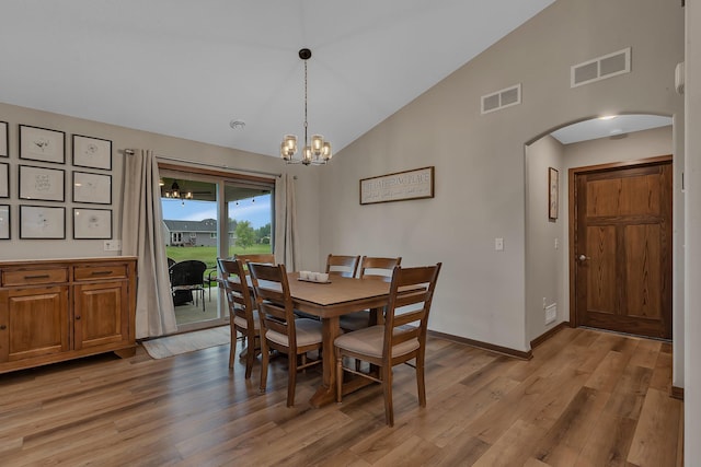 83 Meadow Ln, Cold Spring, MN 56320 - dining space featuring arched walkways, light wood-style floors, a chandelier, high vaulted ceiling, and baseboards