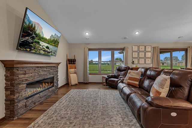 83 Meadow Ln, Cold Spring, MN 56320 - living room featuring a fireplace, baseboards, dark wood-style floors, recessed lighting, and vaulted ceiling
