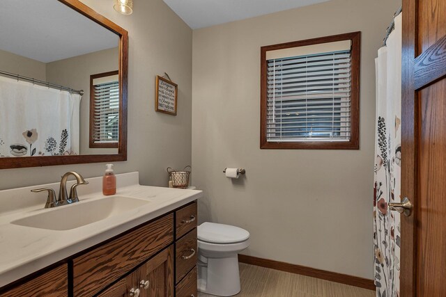 83 Meadow Ln, Cold Spring, MN 56320 - bathroom with vanity, toilet, and baseboards